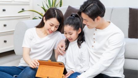 Parents guiding their child to appropriate content on a smartphone, sitting together with a warm and engaged expression, ensuring a safe and educational digital experience.