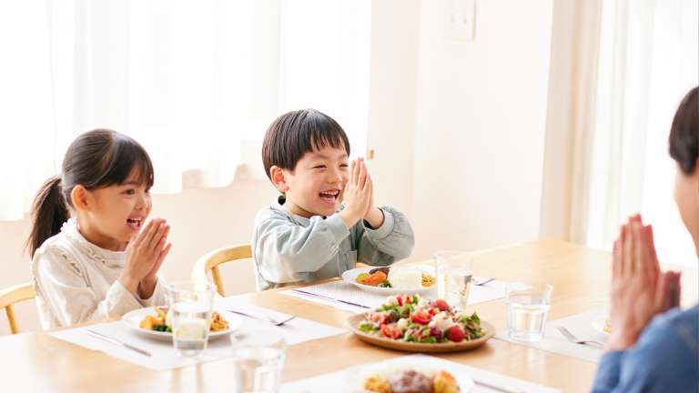 Mother teaching her kids to be grateful in their foods and blessings.
